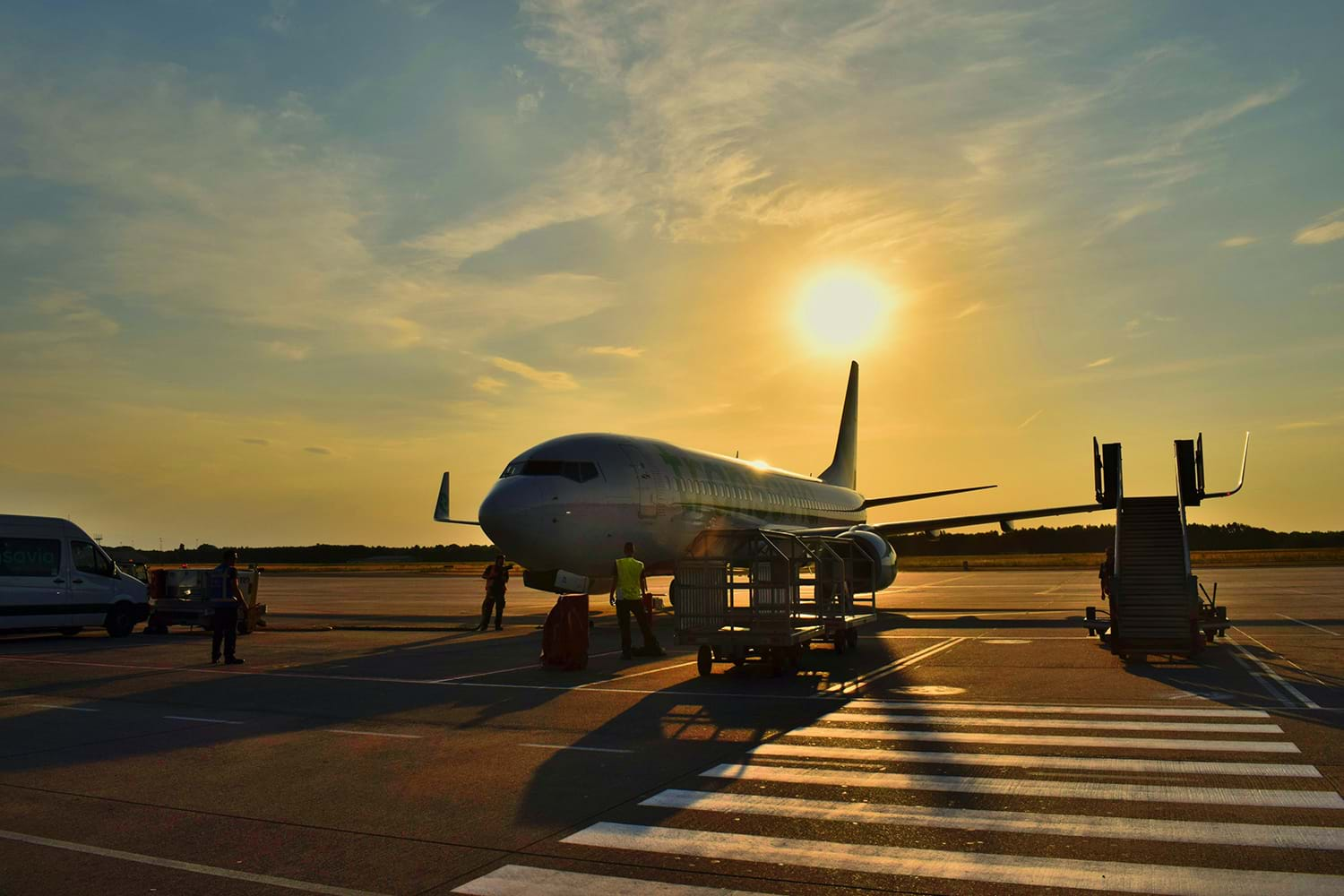 Plane sitting on tarmac at sunrise