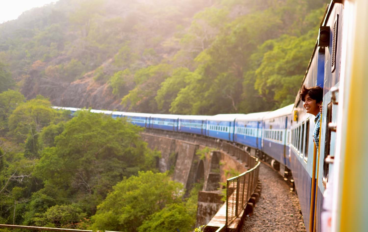 Passenger sticking head out of train watching view