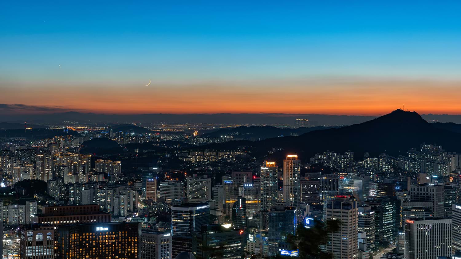 View over city with orange sunset