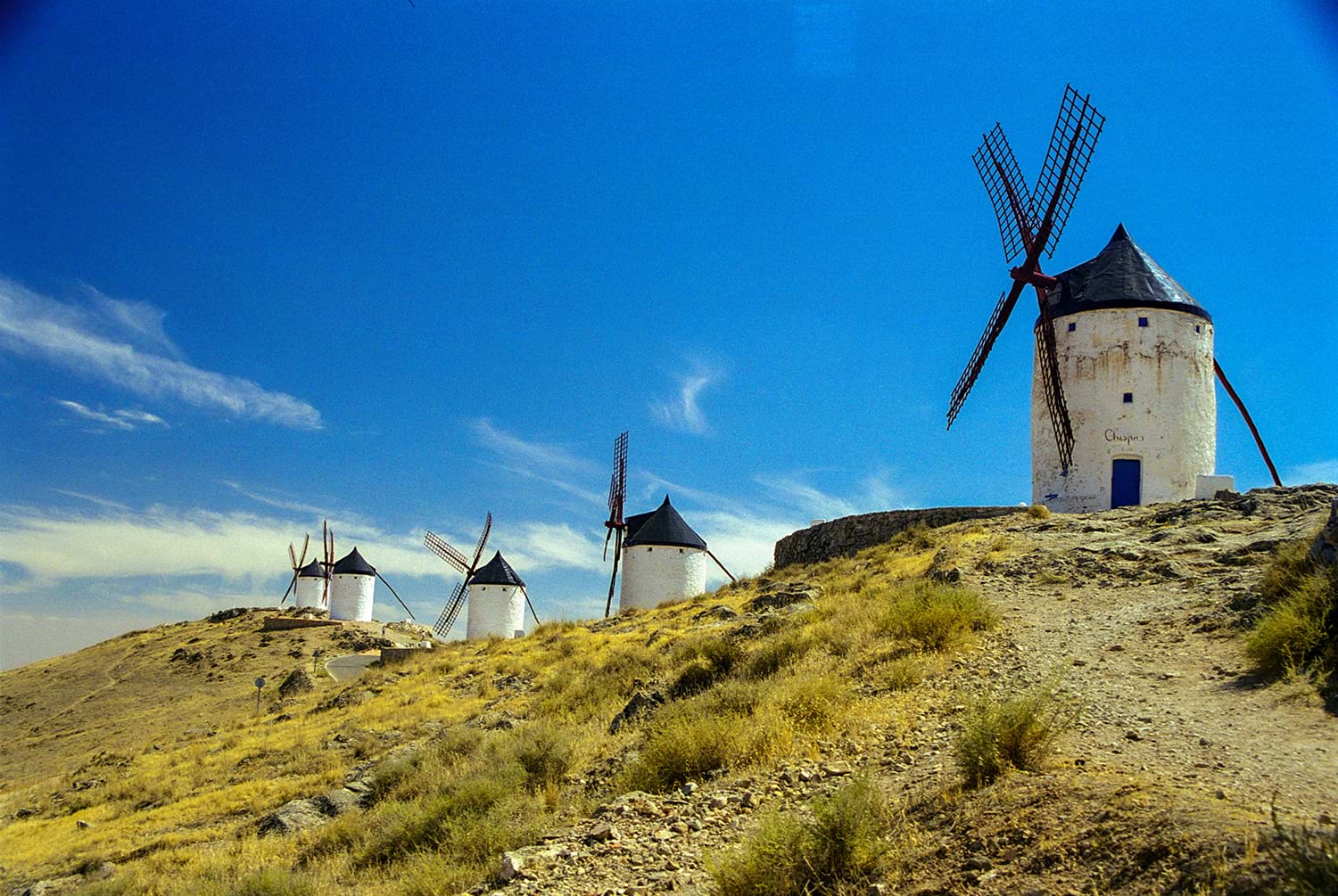 Row of small windmills on hill