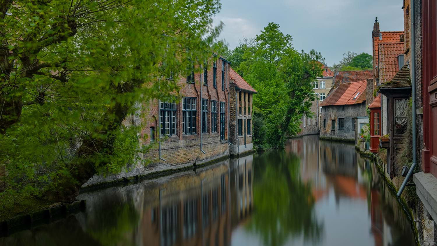 Calm canal between houses in town