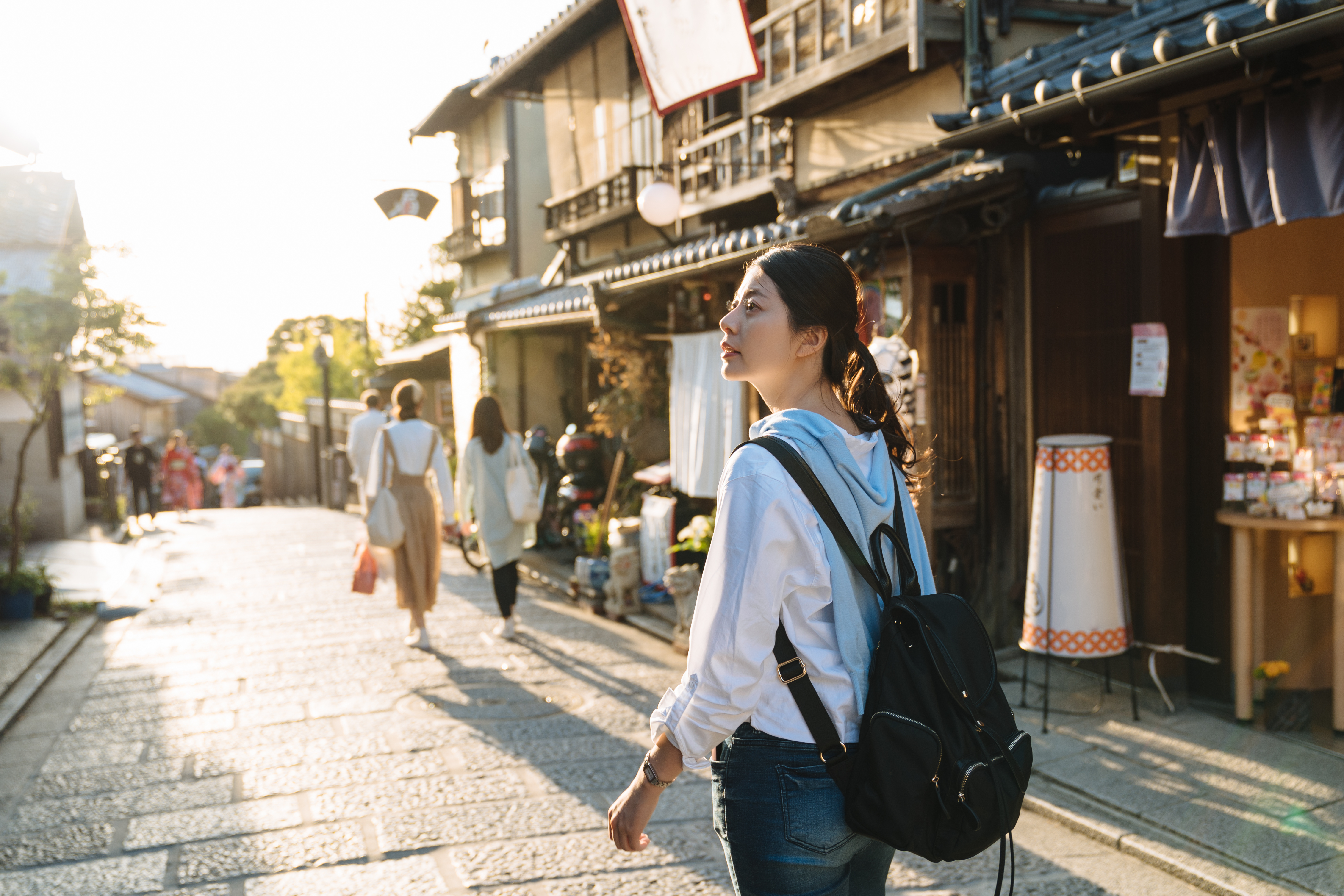 backpacker walking through traditional Japanese town