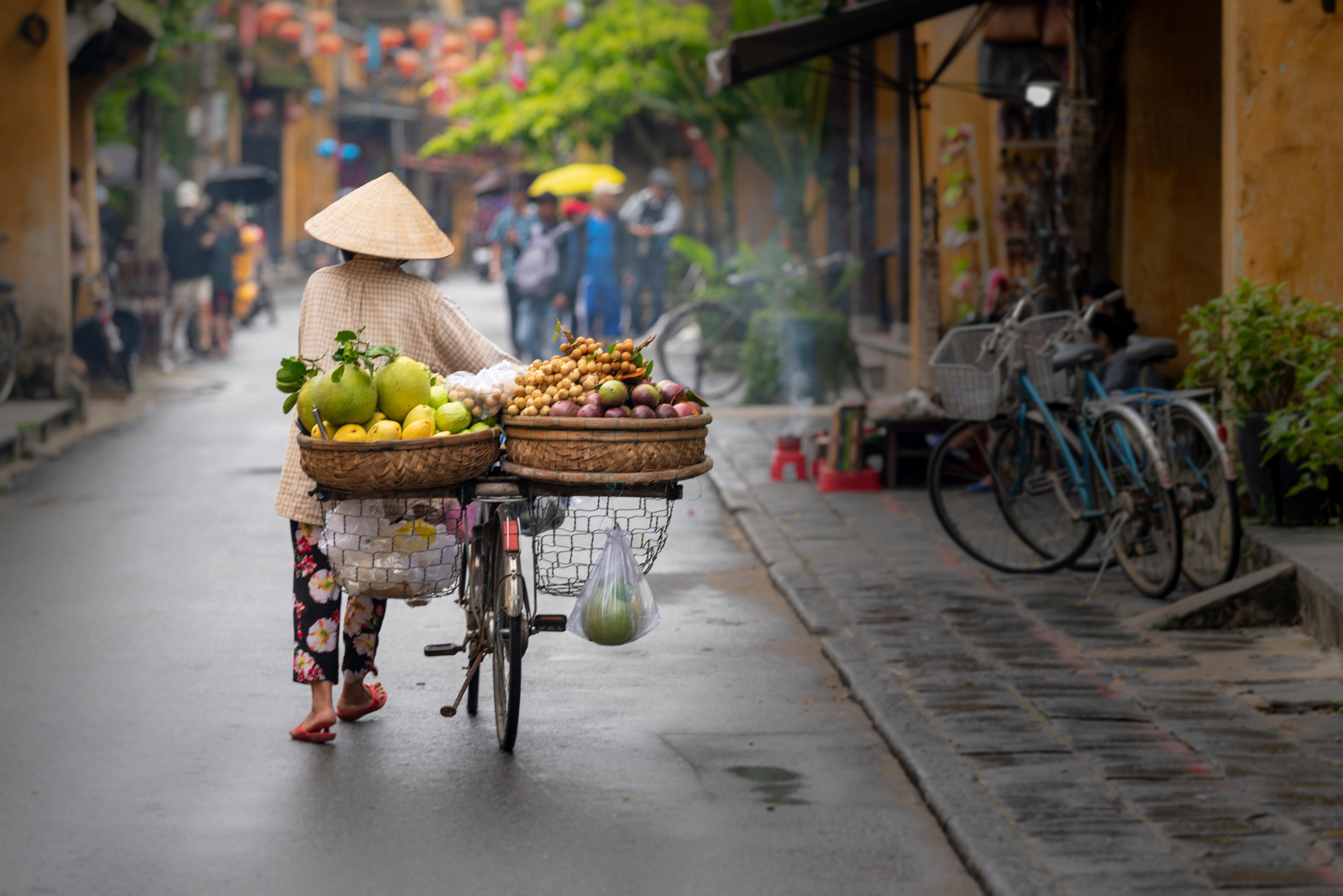 woman walking down street with fruits