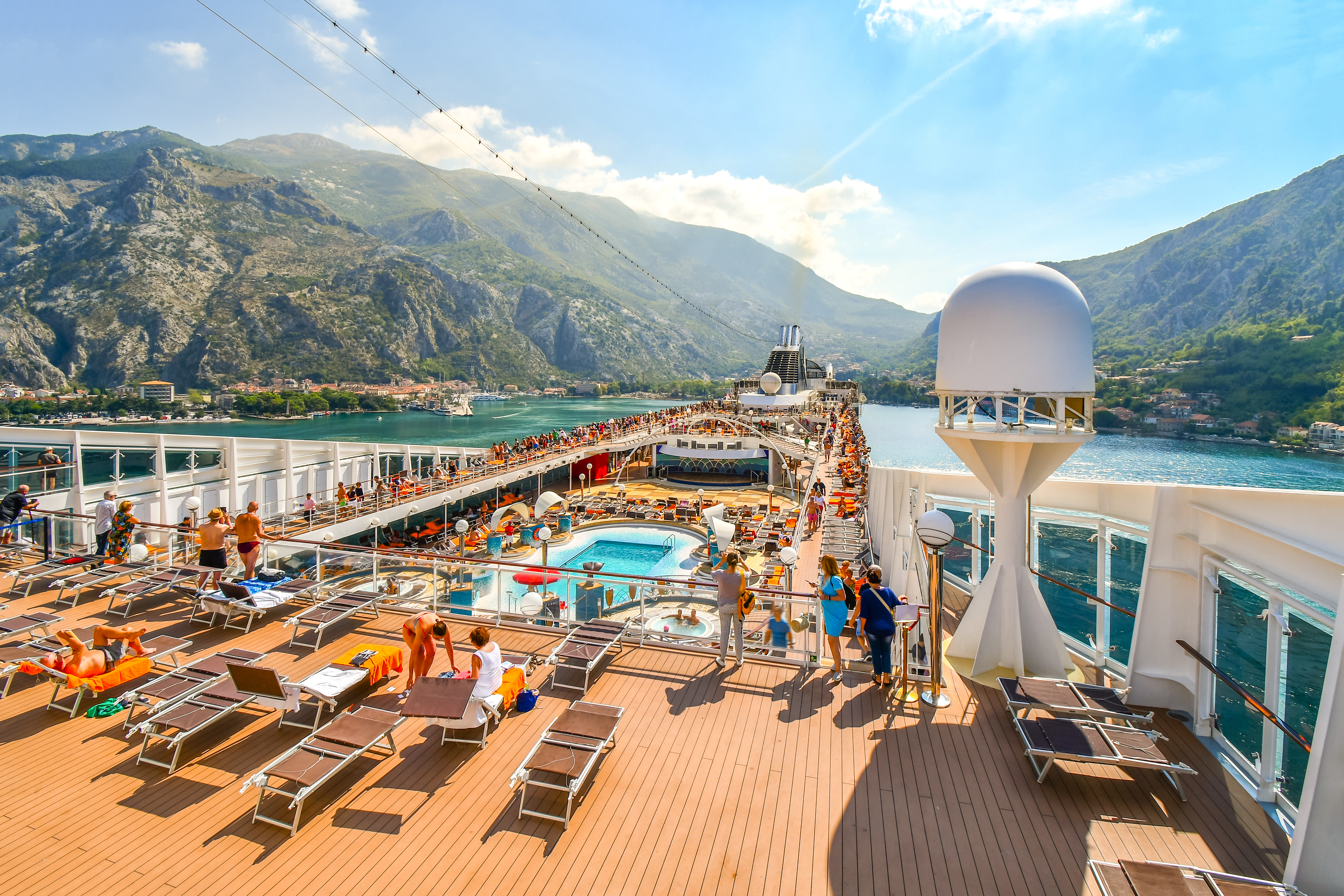 tourists on deck of large cruise ship
