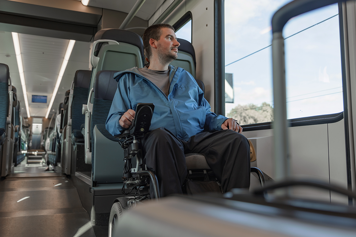Man in wheelchair riding train