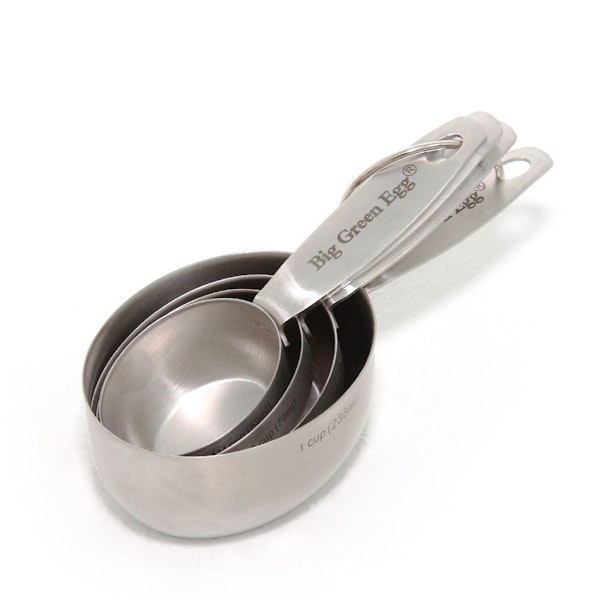 Set of four stainless steel measuring cups featuring metric and imperial measurements. Linked with steel clasp.