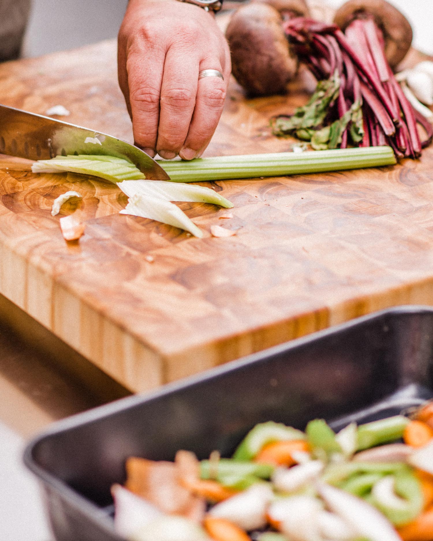 Roughly chop some root vegetables and place them in the bottom of a Roasting Pan