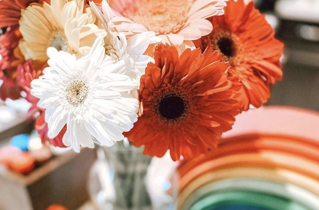 Vibrant bouquet of orange and white gerbera daisies adding cheer to any space.