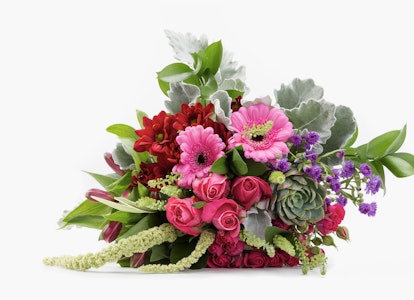 Colorful bouquet of flowers including red roses, pink gerberas, and green succulents with assorted foliage on a white background.