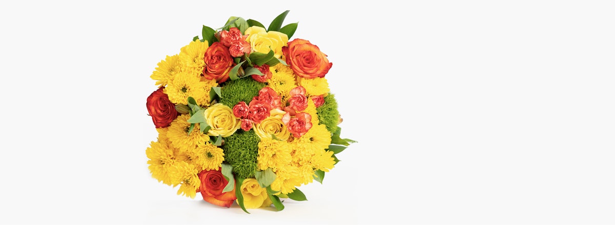 Vibrant floral bouquet featuring yellow roses, orange blooms, and lush greenery.