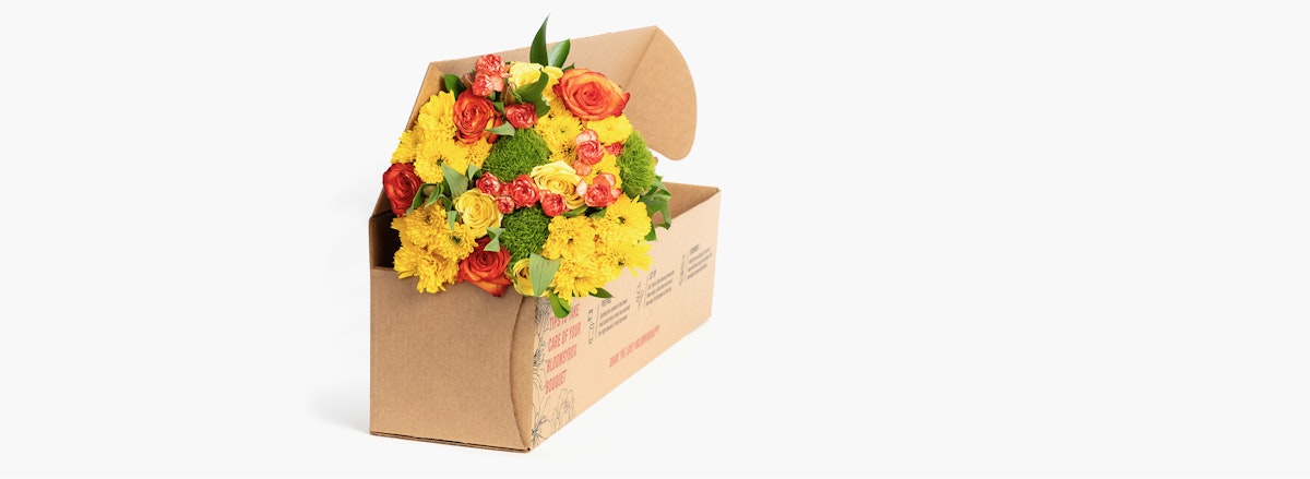 Vibrant yellow and orange floral arrangement in a stylish delivery box, perfect for gifts.