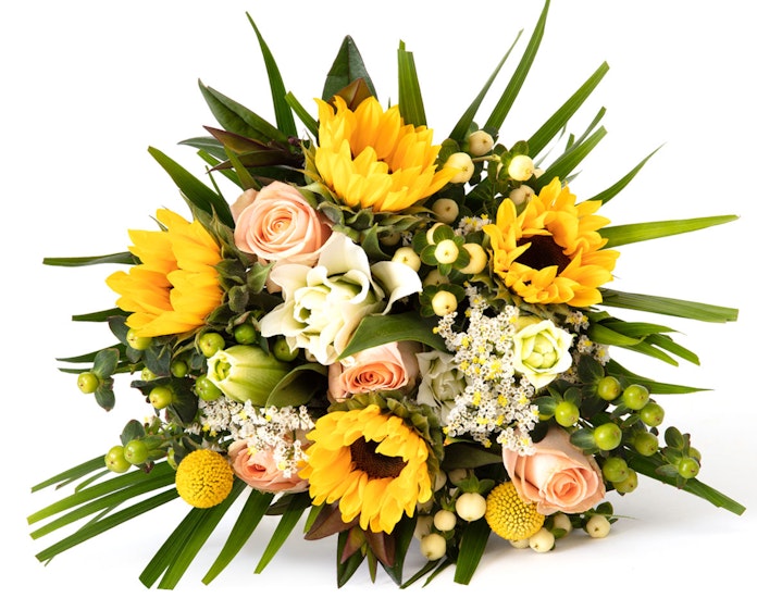 Vibrant bouquet of fresh flowers featuring bright yellow sunflowers, delicate pink roses, white lilies, and green foliage on a white background.