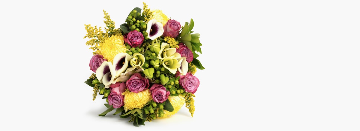 Vibrant floral bouquet featuring pink roses, yellow blooms, and elegant calla lilies.