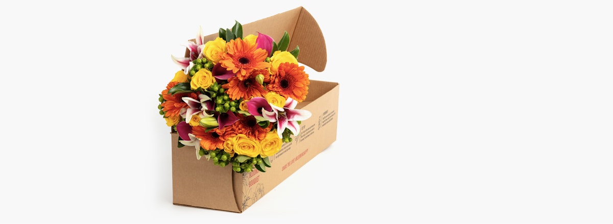 Vibrant bouquet of orange and yellow flowers in a stylish delivery box, perfect for any occasion.