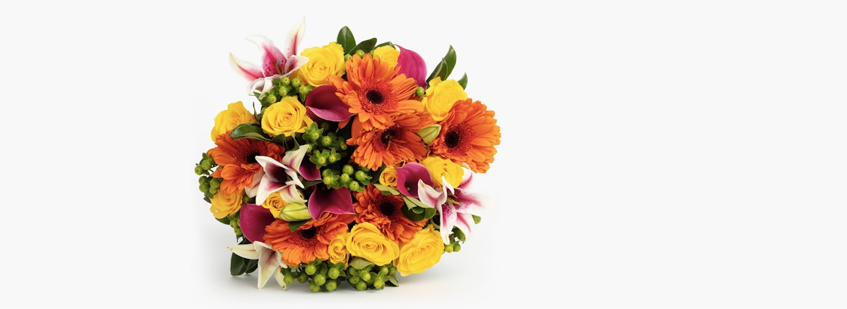 Vibrant bouquet featuring orange gerbera daisies, yellow roses, and lush greenery.