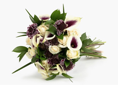 Elegant bouquet of flowers featuring white roses and purple calla lilies with lush green leaves, presented on a white background for a clean, minimalist look.