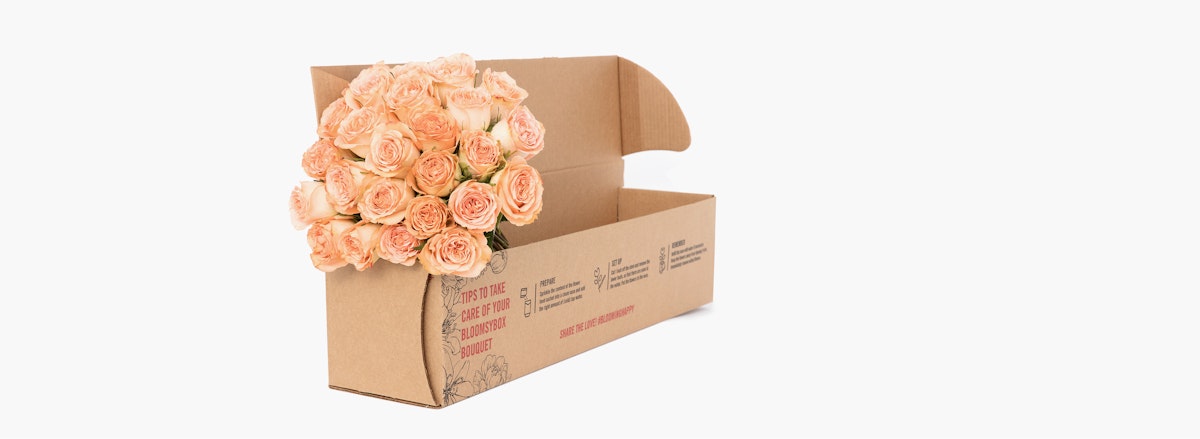 Elegant peach rose bouquet arranged in a sustainable flower box, perfect for gifting.