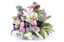 Elegant bouquet of flowers including pink roses, purple tulips, and white lilies with lush greenery, presented against a clean white background.