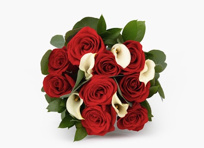 Elegant bouquet of vibrant red roses and delicate white calla lilies arranged together, isolated on a clean white background, symbolizing love and sophistication.