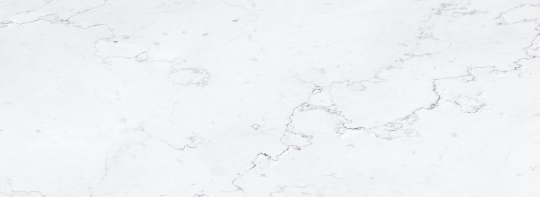 Elegant white marble surface featuring subtle grey veining, perfect for modern decor.