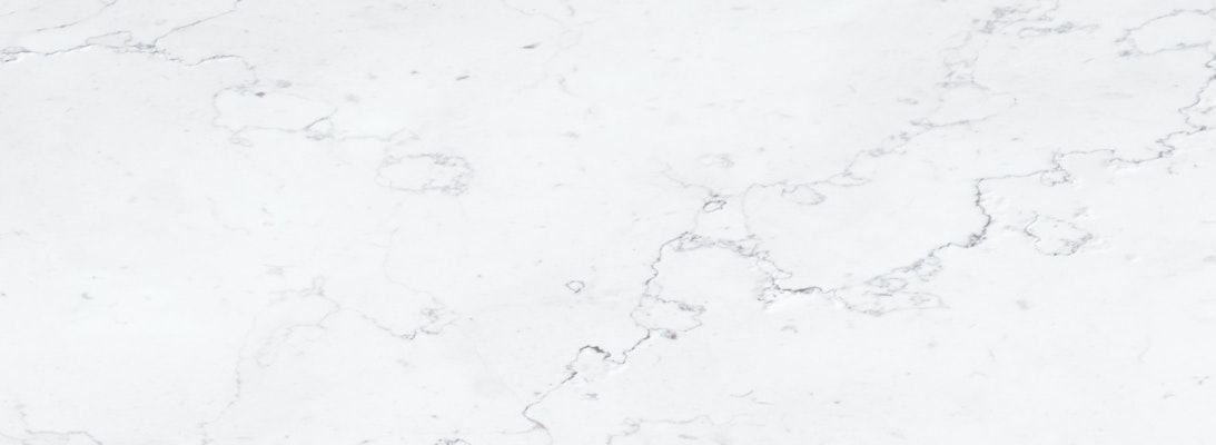 Elegant white marble surface featuring subtle grey veining, perfect for modern decor.