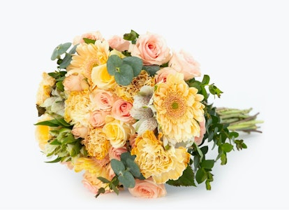 Beautiful spring bouquet of mixed flowers including pink roses, yellow dahlias, and greenery on a white background, perfect for weddings or special occasions.
