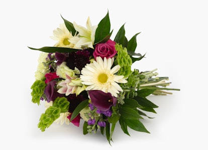 Elegant bouquet featuring a mix of colorful flowers, including roses and daisies, with green foliage accents on a white background.