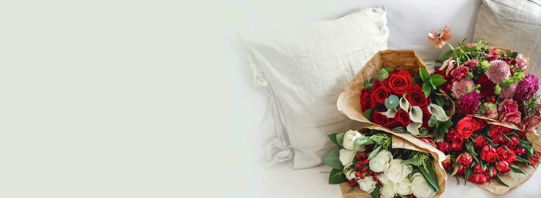 Three stunning floral arrangements featuring red roses and assorted blooms, beautifully presented.