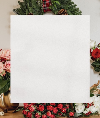 Christmas wreath adorned with vibrant flowers and greenery, perfect for festive decor.