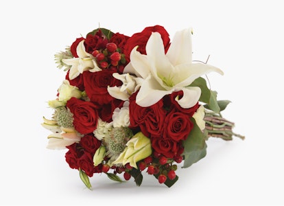Beautiful bouquet of red roses and white lilies with greenery tied together, set against a clean white background, ideal for weddings or romantic occasions.