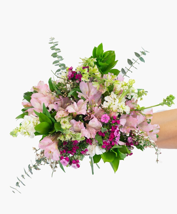 A vibrant bouquet of pink and white flowers, accented with lush greenery, ideal for celebrations.