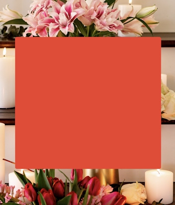 Elegant floral arrangement featuring pink lilies, tulips, and candles for a serene atmosphere.
