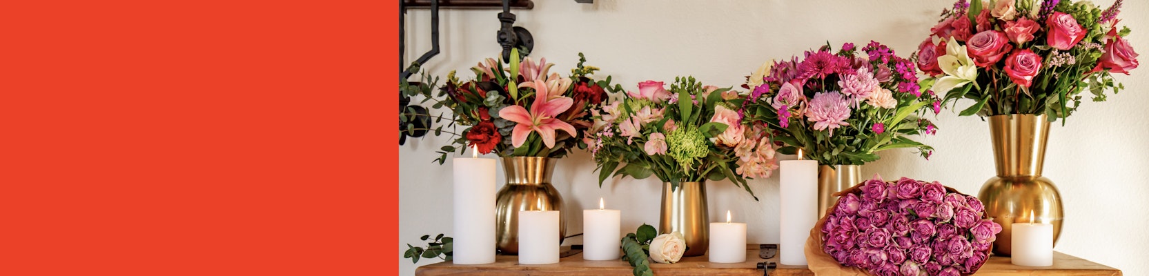 Elegant floral display featuring pink roses, lilies, and mixed blooms in gold vases.