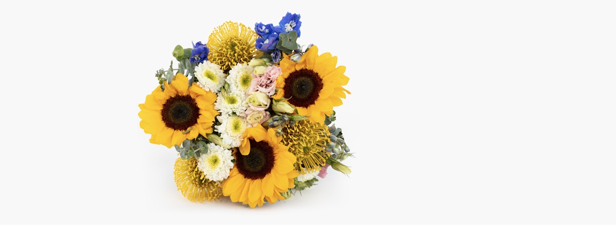 Vibrant bouquet featuring sunflowers, daisies, and pastel roses, perfect for cheerful occasions.