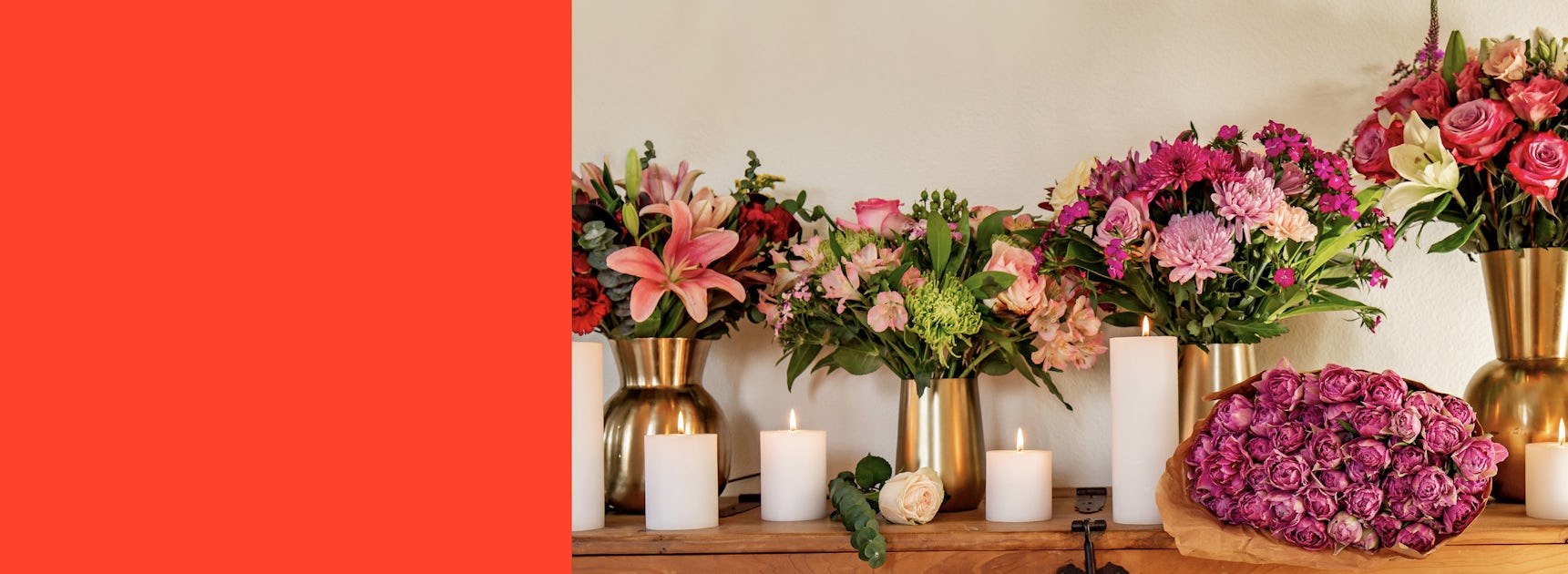 Vibrant floral arrangements and elegant candles create a stunning centerpiece display.