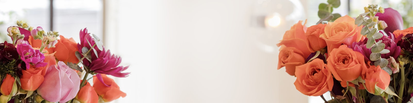 Vibrant bouquet of orange roses and mixed flowers, perfect for celebrations and events.