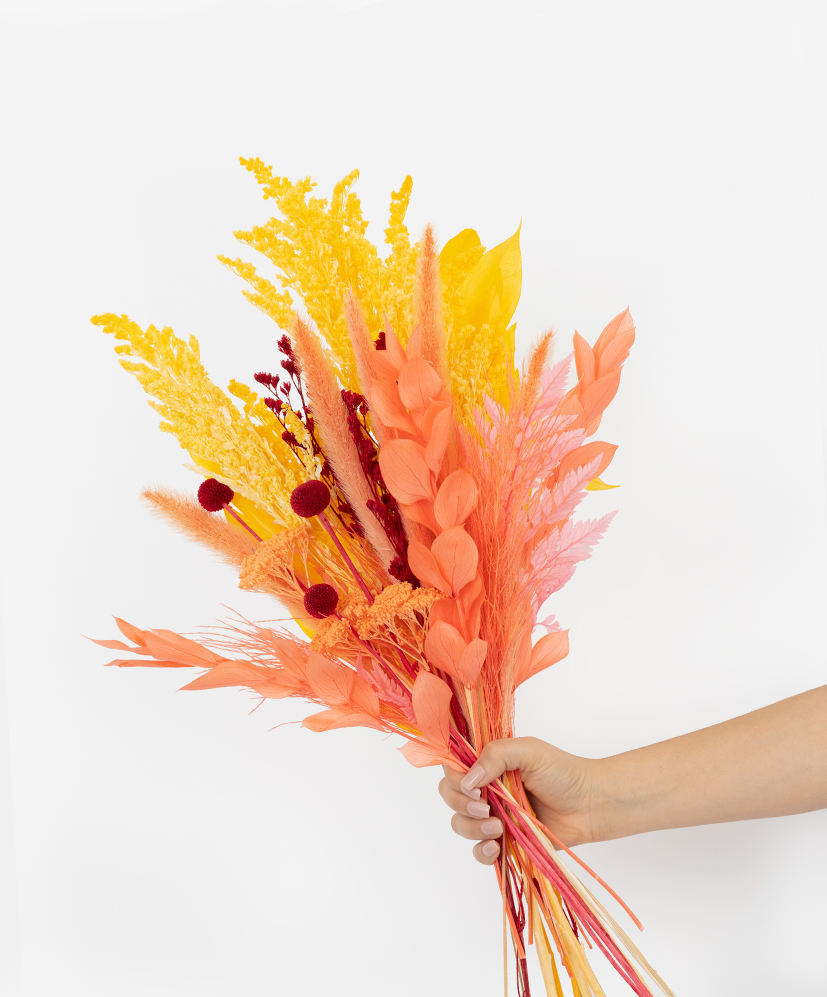 Vibrant bouquet of dried flowers in yellow and pink hues, perfect for home decor.