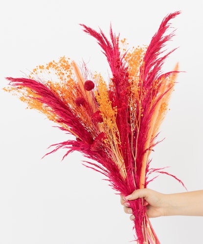Vibrant bouquet featuring red and orange dried flowers for a striking home decor accent.