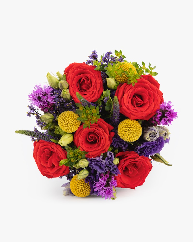 Vibrant bouquet of red roses, purple accents, and green foliage against a white background, ideal for special occasions or as an elegant home decor piece.