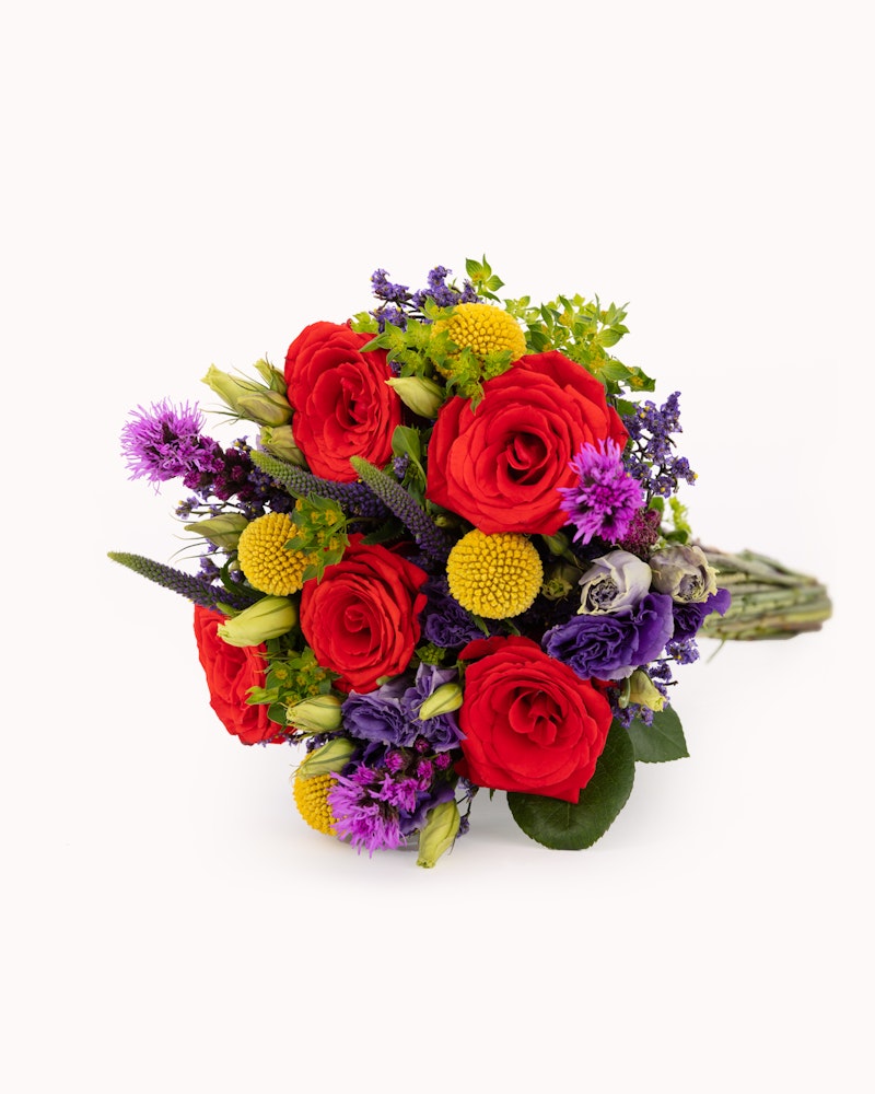 A vibrant bouquet with red roses, yellow blooms, and purple accents, arranged beautifully against a white background, perfect for gifts or decoration.