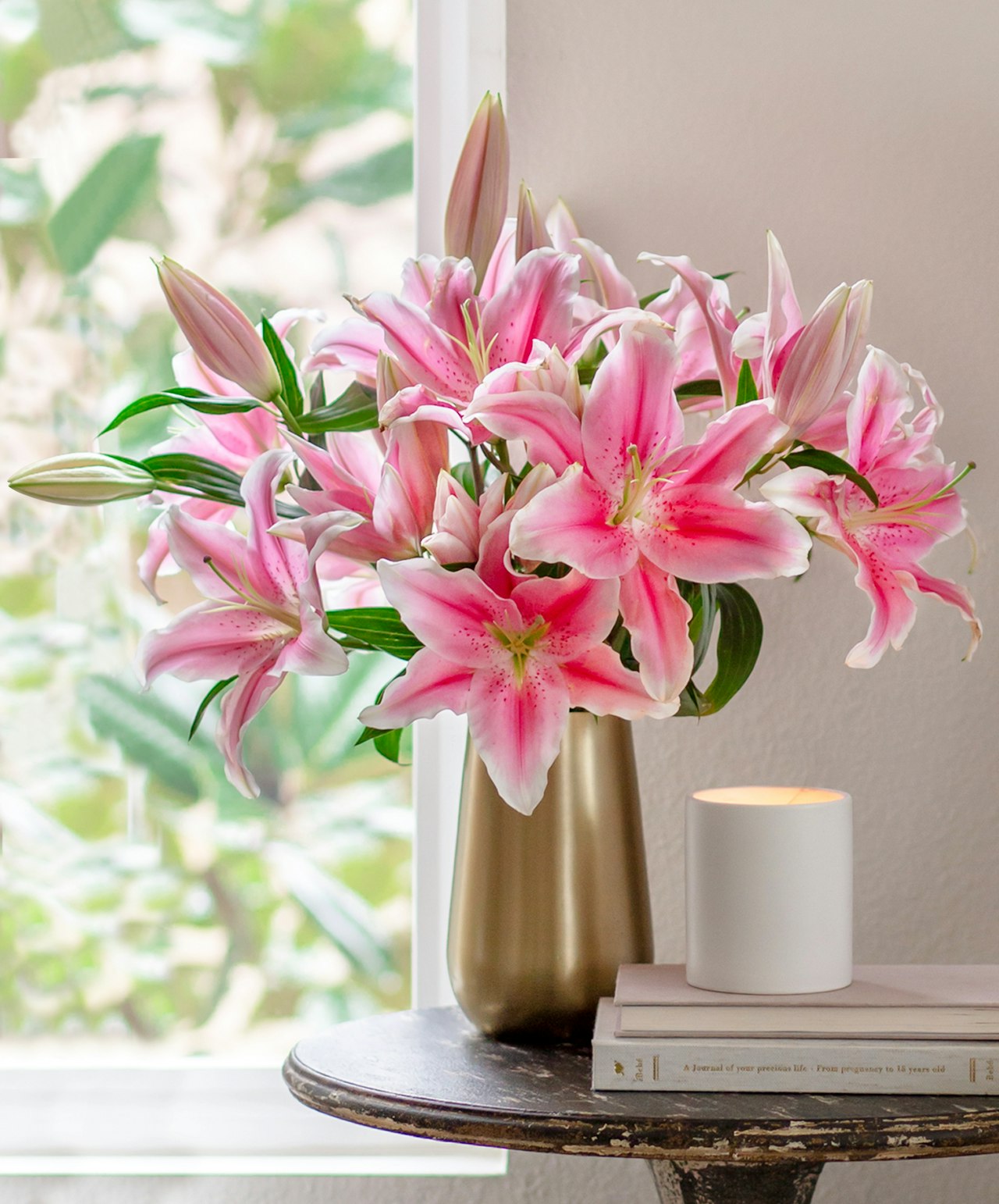 Elegant pink lilies in a stylish vase, enhancing a bright and serene living space.