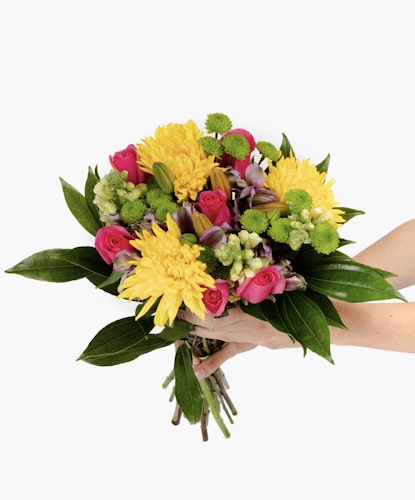 Bright and cheerful floral bouquet featuring pink roses, yellow daisies, and green accents.