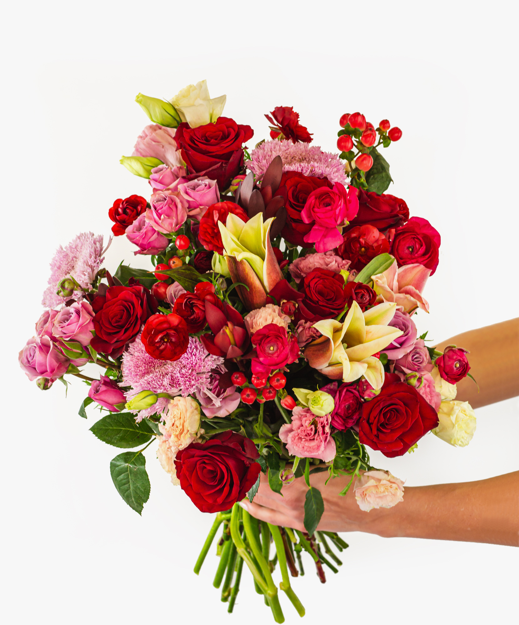 Vibrant mixed bouquet featuring red roses, lilies, and pink blooms for any celebration.