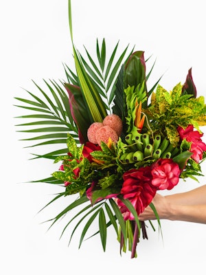 Vibrant tropical bouquet featuring lush greens, red flowers, and unique textures for any occasion.