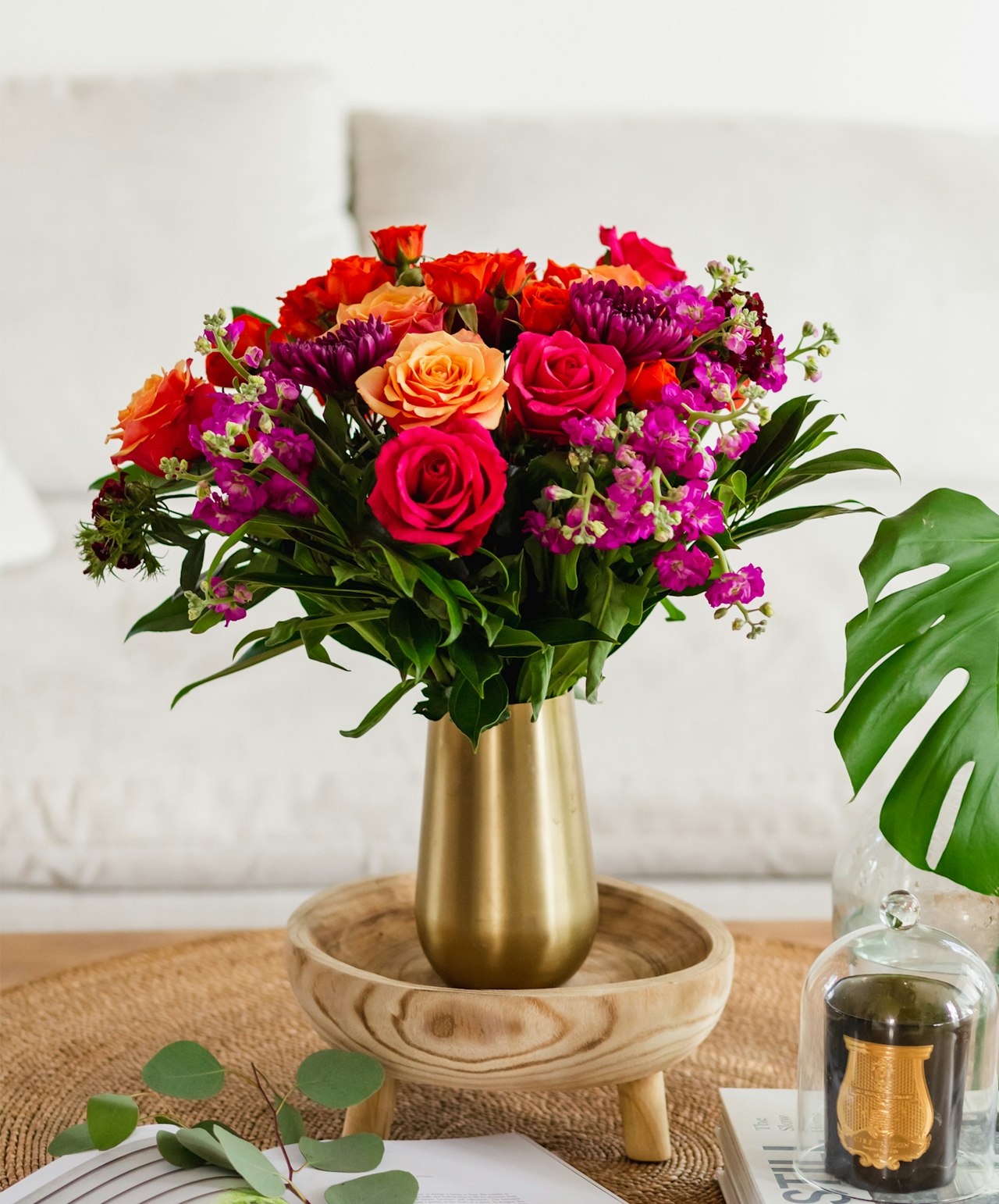 Vibrant floral arrangement featuring mixed roses and colorful blooms in a stylish vase.