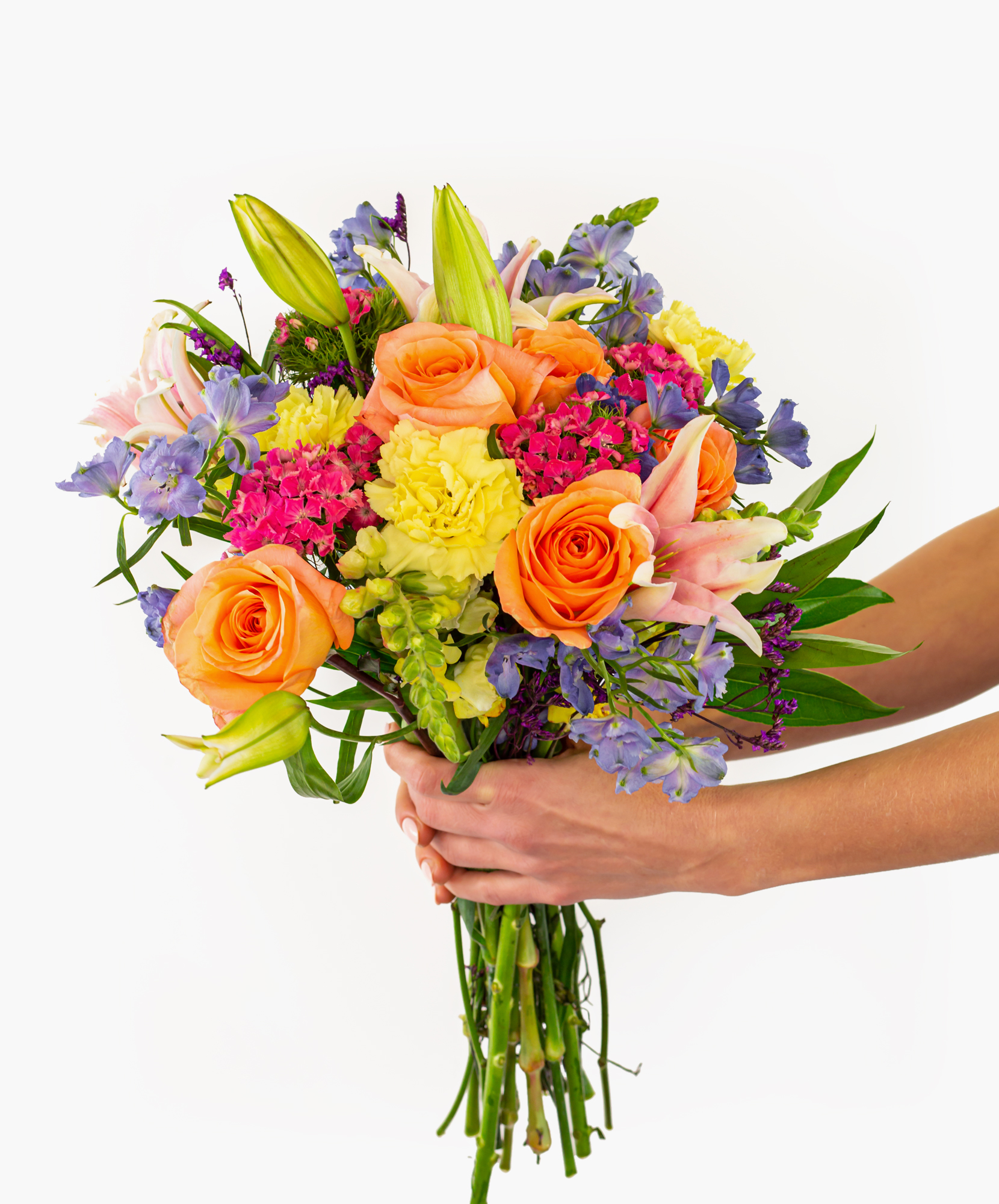 Vibrant floral bouquet featuring orange roses, lilies, and colorful blooms in hand.