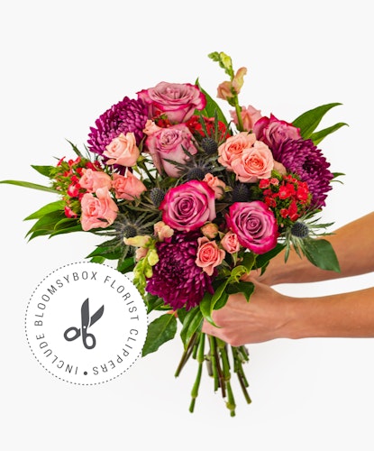 Vibrant floral bouquet featuring pink roses, asters, and greenery, perfect for any celebration.