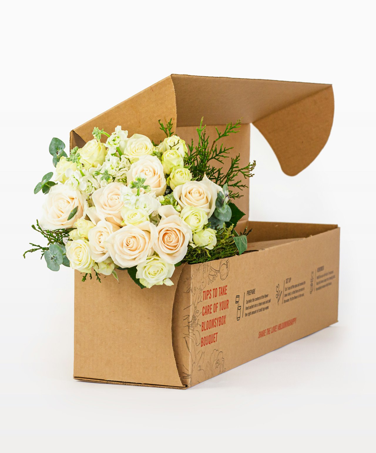 Charming bouquet of cream roses and greenery in an eco-friendly delivery box.