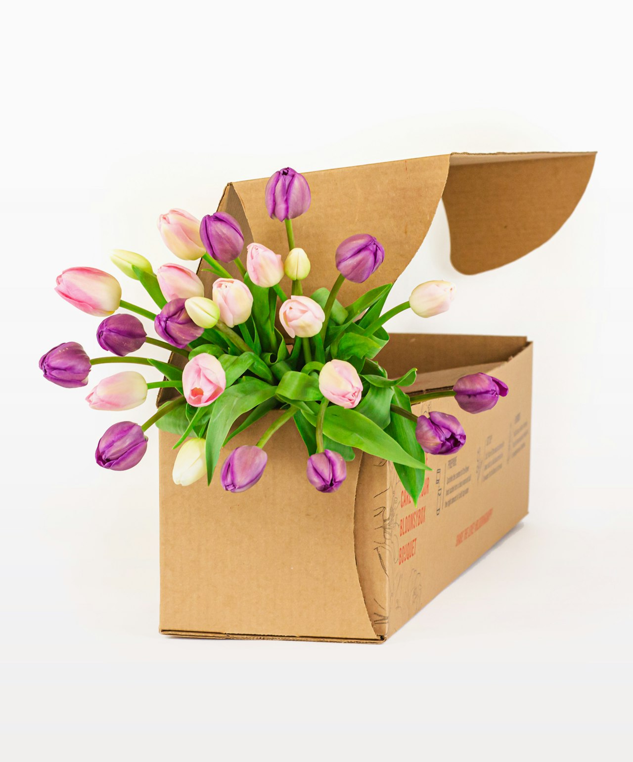 Charming box of vibrant tulips in shades of pink and purple, ready to brighten any space.