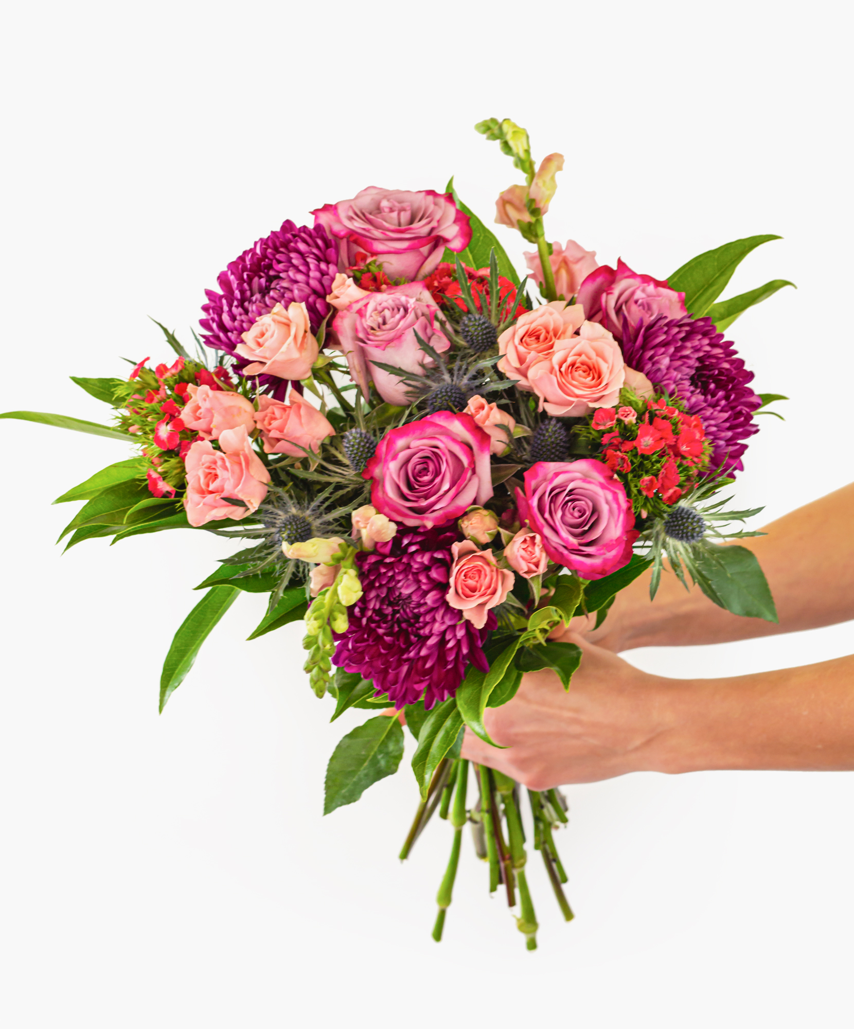 Vibrant bouquet featuring pink roses, asters, and fresh greenery, perfect for any celebration.